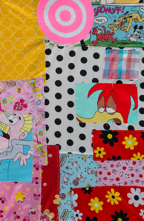A vibrant textile assemblage that juxtaposes Western cartoon icons like Mickey Mouse and Woody Woodpecker with Japanese kawaii characters such as Kirby and Hello Kitty. The composition uses a collage-like patchwork technique, blending nostalgic pop culture imagery with bold patterns and hand-painted elements. The mood is playful and energetic, exploring the intersection of global media and consumerist aesthetics.
